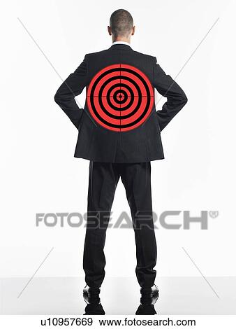 Stock Photo - Young businessman with target on back, back view. Fotosearch