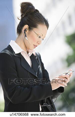 Young businesswoman using mobile outdoors View Large Photo Image Stock Photo - Young businesswoman using mobile outdoors. Fotosearch