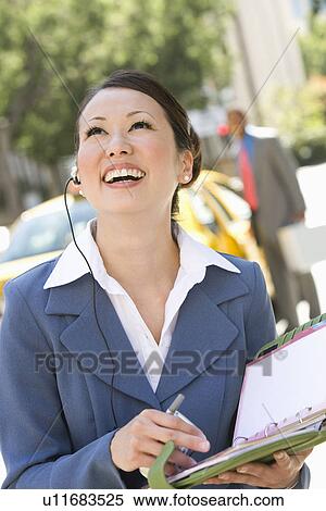 Young businesswoman with diary, laughing View Large Photo Image Stock Photography - Young businesswoman with diary, laughing. Fotosearch