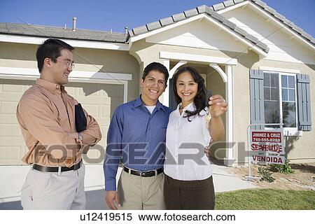 Young couple buying house, holding keys View Large Photo Image Stock Photography - Young couple buying house, holding keys. Fotosearch