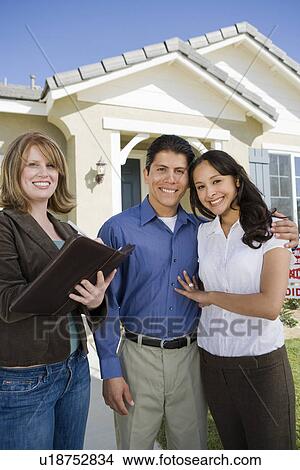Young couple buying house, signing contract View Large Photo Image Picture - Young couple buying house, signing contract. Fotosearch