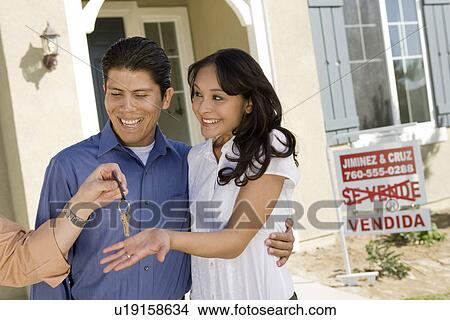 Young couple buying house, taking keys View Large Photo Image Picture - Young couple buying house, taking keys. Fotosearch