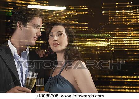Young Couple Drinking Champagne Against Night Skyline, Close-up View Large Photo Image Stock Photo - Young Couple Drinking Champagne Against Night Skyline, Close-up. Fotosearch