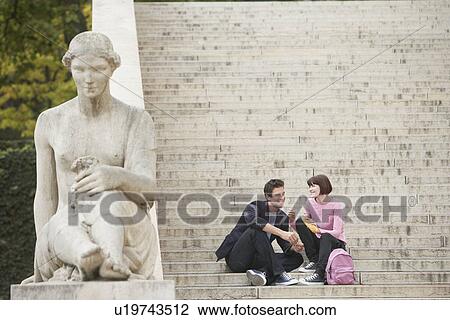 Young couple eating lunch, sitting on stairway View Large Photo Image Stock Image - Young couple eating lunch, sitting on stairway. Fotosearch