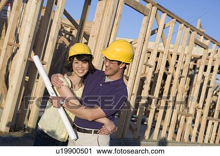 Young couple in construction site View Large Photo Image Stock Image - Young couple in construction site. Fotosearch