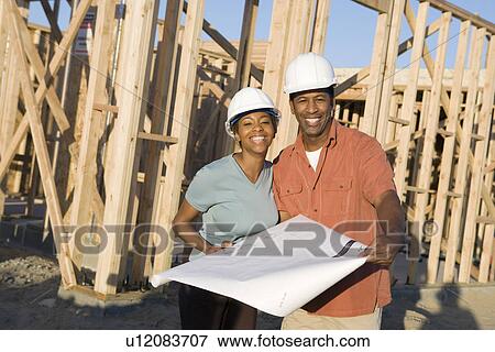 Young couple in construction site View Large Photo Image Stock Photo - Young couple in construction site. Fotosearch