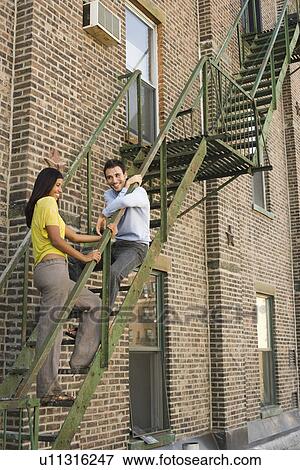 Stock Photo - Young Couple on Fire Escape. Fotosearch