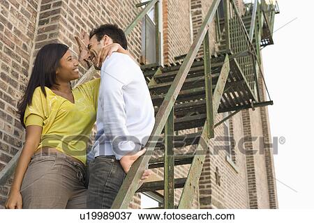 Stock Photo - Young Couple on Fire Escape. Fotosearch