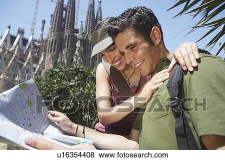 Stock Photo - Young Couple Reading City Map. Fotosearch