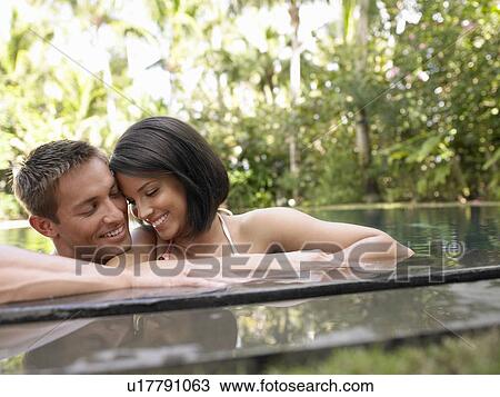 Young Couple Relaxing in Swimming Pool View Large Photo Image Stock Image - Young Couple Relaxing in Swimming Pool. Fotosearch