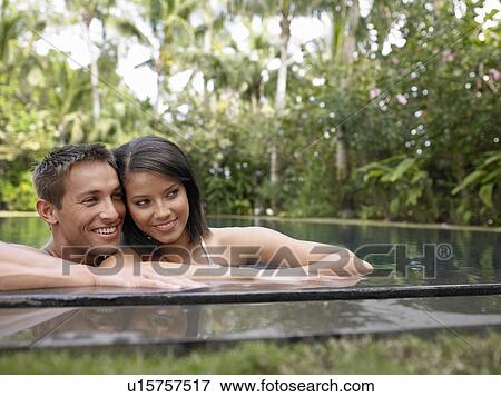 Young Couple Relaxing in Swimming Pool View Large Photo Image Stock Photo - Young Couple Relaxing in Swimming Pool. Fotosearch