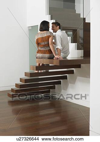 Picture - Young Couple Sitting on Stairs. Fotosearch