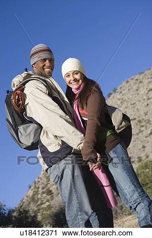 Young couple stand holding hands View Large Photo Image Stock Image - Young couple stand holding hands. Fotosearch