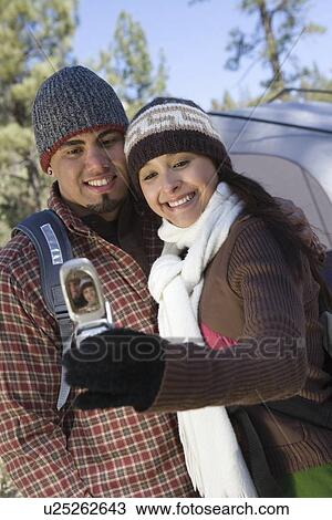 Young couple take self portrait on mobile phone View Large Photo Image Stock Image - Young couple take self portrait on mobile phone. Fotosearch