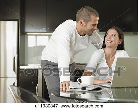 Young Couple Using Laptop View Large Photo Image Stock Photo - Young Couple Using Laptop. Fotosearch