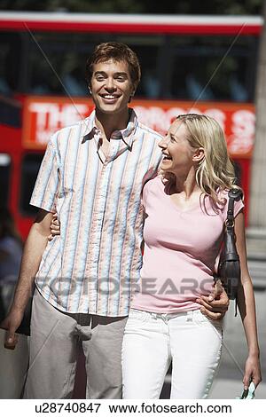 Stock Photo - Young couple walking on street in London. Fotosearch