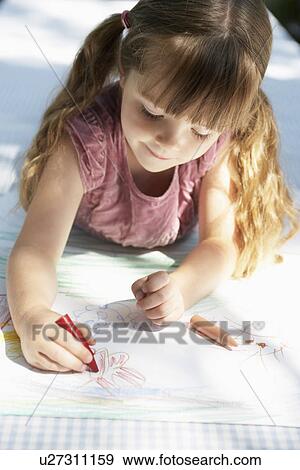 Young girl lying on table in back yard drawing View Large Photo Image Stock Photo - Young girl lying on table in back yard drawing. Fotosearch