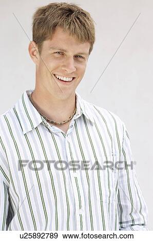 Young Man in studio, portrait, half length View Large Photo Image Stock Photo - Young Man in studio, portrait, half length. Fotosearch
