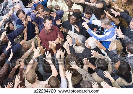 Young man surrounded by crowd View Large Photo Image Stock Image - Young man surrounded by crowd. Fotosearch
