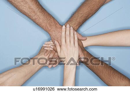 Young men and women piling hands on top of each other, close-up on forearms and hands View Large Photo Image Stock Photograph - Young men and women piling hands on top of each other, close-up on forearms and hands. Fotosearch