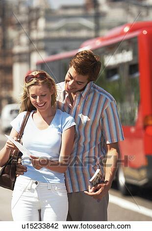 Young vacationing couple on London street reading map View Large Photo Image Stock Image - Young vacationing couple on London street reading map. Fotosearch