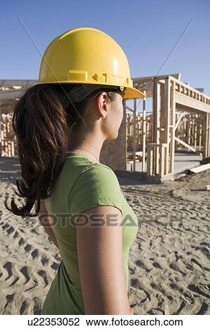 Young woman in construction site View Large Photo Image Stock Image - Young woman in construction site. Fotosearch