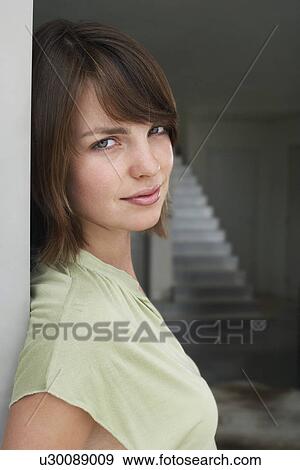 Young woman in doorway, portrait View Large Photo Image Stock Photo - Young woman in doorway, portrait. Fotosearch
