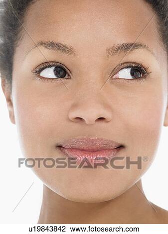 Stock Image - Young Woman looking away, close up, front view. Fotosearch