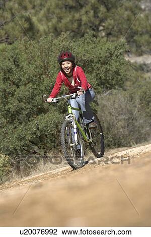 Young Woman Mountain Biking in field View Large Photo Image Stock Image - Young Woman Mountain Biking in field. Fotosearch