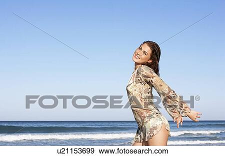 Young woman posing by sea, half-length View Large Photo Image Stock Photo - Young woman posing by sea, half-length. Fotosearch