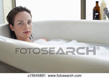 Young woman relaxing in bubble bath View Large Photo Image Stock Image - Young woman relaxing in bubble bath. Fotosearch