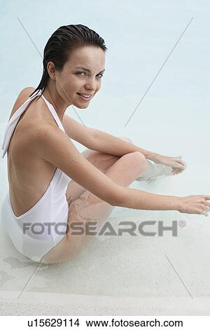 Young woman relaxing in swimming pool, portrait, elevated view View Large Photo Image Picture - Young woman relaxing in swimming pool, portrait, elevated view. Fotosearch