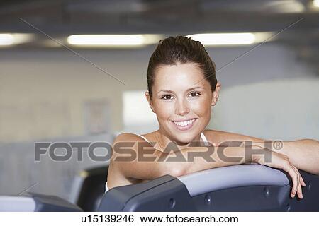 Young Woman resting on treadmill at Health Club, portrait View Large Photo Image Stock Photograph - Young Woman resting on treadmill at Health Club, portrait. Fotosearch