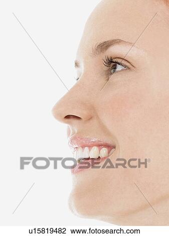 Young Woman Smiling, close up, side view View Large Photo Image Stock Image - Young Woman Smiling, close up, side view. Fotosearch