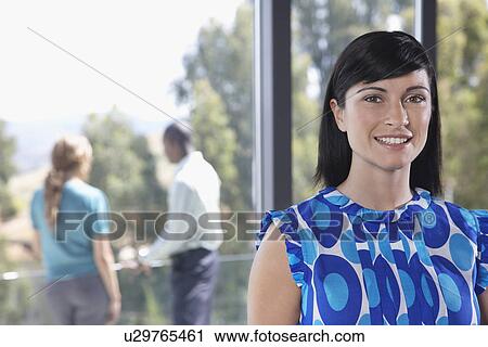 Young woman smiling indoors, portrait View Large Photo Image Stock Image - Young woman smiling indoors, portrait. Fotosearch