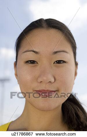Stock Photo - Young woman smiling, portrait. Fotosearch