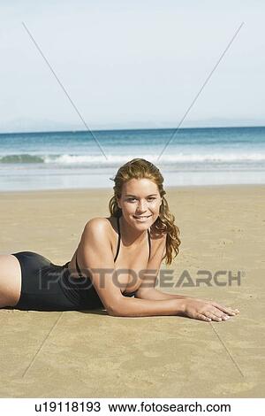 Young Woman Sunbathing on Beach View Large Photo Image Stock Image - Young Woman Sunbathing on Beach. Fotosearch