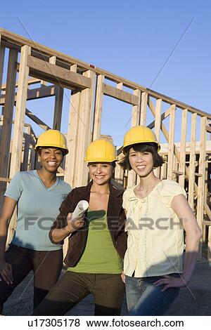 Stock Photo - Young women in construction site. Fotosearch