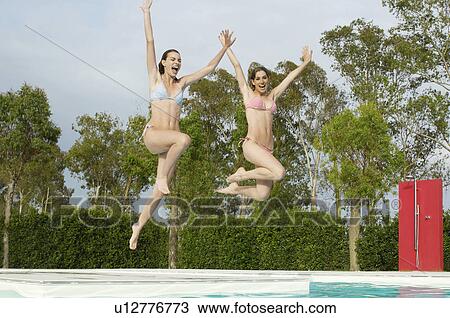 Young Women Jumping into Swimming Pool View Large Photo Image Stock Image - Young Women Jumping into Swimming Pool. Fotosearch