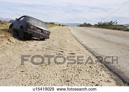 Stock Photo - Abandoned car on roadside. Fotosearch
