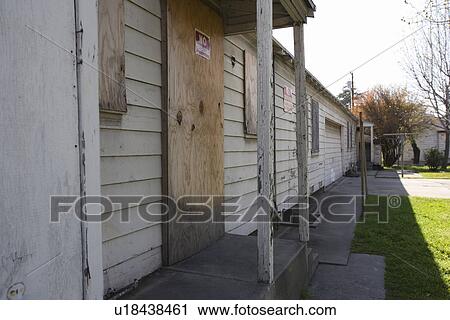 Stock Image - Abandoned House With Boarded Up Windows. Fotosearch