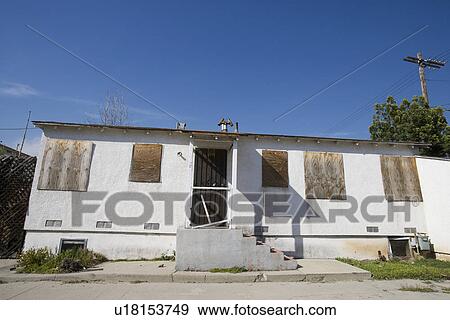 Stock Photo - Abandoned House With Boarded Up Windows. Fotosearch