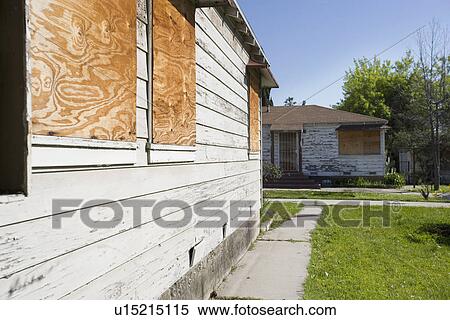 Stock Photography - Abandoned Houses With Boarded Up Windows. Fotosearch