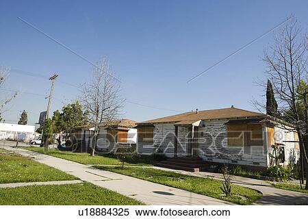 Stock Photography - Abandoned Houses With Boarded Up Windows. Fotosearch