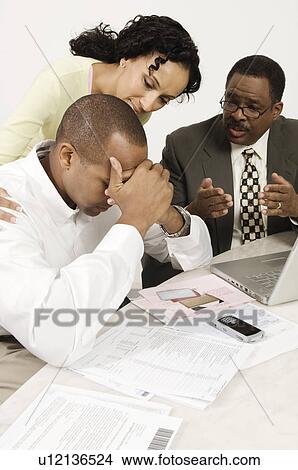 Accountant Giving Couple Bad News View Large Photo Image Picture - Accountant Giving Couple Bad News. Fotosearch