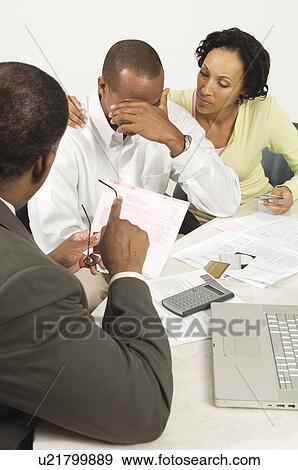 Stock Photo - Accountant Giving Couple Bad News. Fotosearch