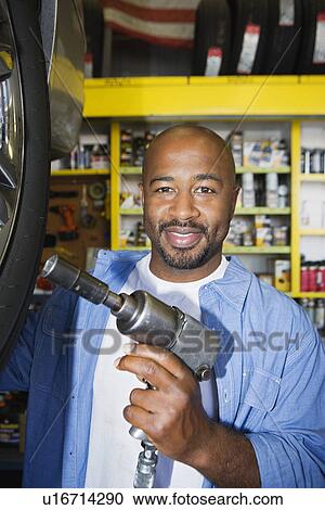 Auto Mechanic Working on a Tire View Large Photo Image Stock Image - Auto Mechanic Working on a Tire. Fotosearch
