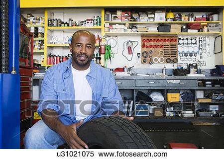 Auto Mechanic Working on a Tire View Large Photo Image Stock Photography - Auto Mechanic Working on a Tire. Fotosearch