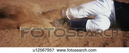 Baseball player lying in dirt, low section View Large Photo Image Stock Photo - Baseball player lying in dirt, low section. Fotosearch
