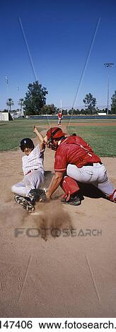 Baseball player sliding into base View Large Photo Image Stock Photograph - Baseball player sliding into base. Fotosearch